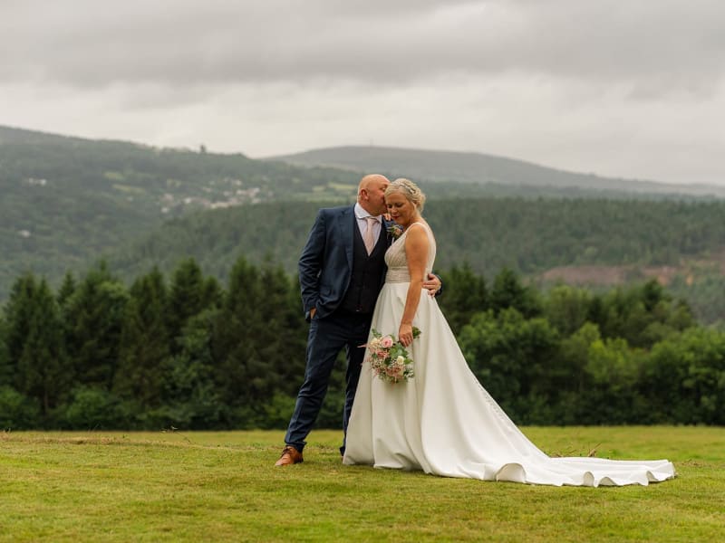 wedding couple posed against the Tamar Valley backdrop