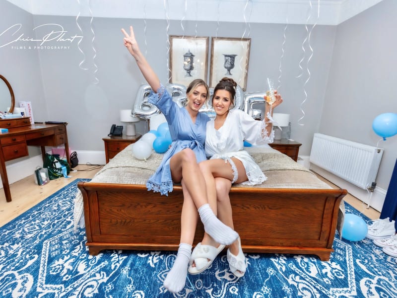 Bride and bridesmaid having fun getting ready